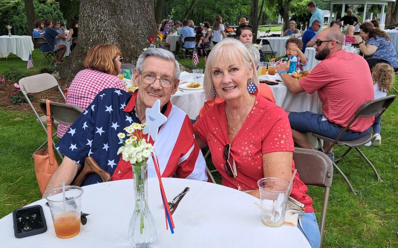 Megan Broome/The Clayton Tribune. Jerry and Janie Walker from Toccoa, Ga. enjoy an Independence Day cookout and live music by Hunter Grayson on the Oaklawn at a celebration at The Dillard House celebration July 3.