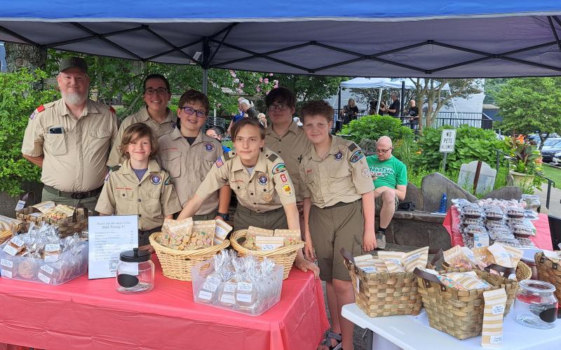 Megan Broome/The Clayton Tribune. Boy Scouts of America Troop 6 held a bake sale during the First Friday Fest in Clayton July 7. The event raised $1,988 for Troop 6 with the band “Playing it Forward” performing. The band plays 100 percent for charity. Pictured are some Boy Scouts from Troop 6.