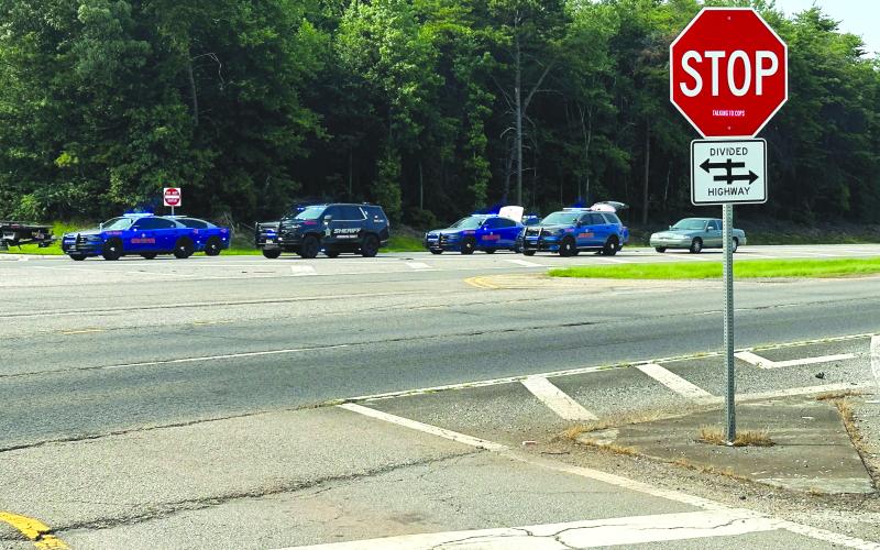 Photo courtesy Habersham County Public Information. Law enforcement vehicles are parked in a line on Sunday, July 16, at the crash scene in Habersham County as five people died.