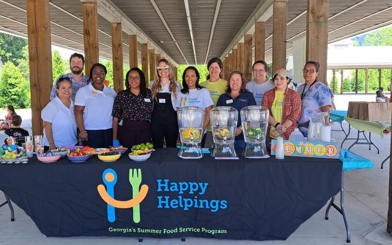 Megan Broome/The Clayton Tribune. The Georgia Department of Early Care and Learning’s (DECAL) Nutrition Services Division partnered with Rabun County Family Connection to kick-off Happy Helpings, Georgia’s Food Service Program for Kids. Pictured at the hydration station are Tina McLaren; Clayton Adams; Morgan Chapman; Nkem Ijeh; Diana Myers; Tamika Boone; Laura Lane; Misty McCall; Cindy Kicklighter; Jennifer Davenport; and Alexzandra Almanza.