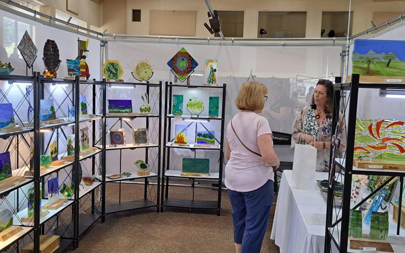 Megan Broome/The Clayton Tribune. Valerie Wheeler displays her beautiful Verre Art fused glass creations during the Painted Fern Art Festival.