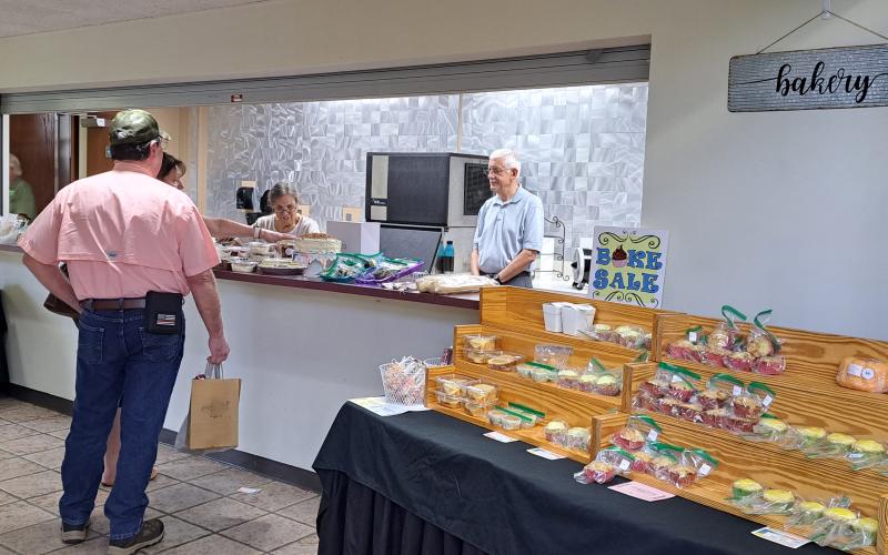 Megan Broome/The Clayton Tribune. Angel and David Dobs volunteer at the bake sale during the Painted Fern Art Festival at the Rabun County Civic Center July 8 and 9. All proceeds for the bake sale benefited the North Georgia Arts Guild Scholarship Program.