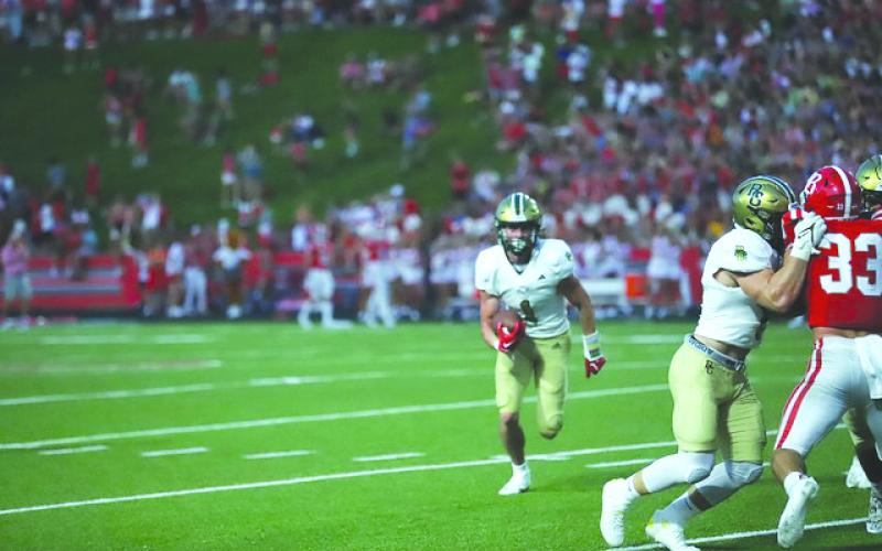Photo courtesy Christy Kirkpatrick. RGNS senior Trey Horne runs around the corner against Baylor as Horne had 207 all-purpose yards during the Eagles’ 35-24 victory.
