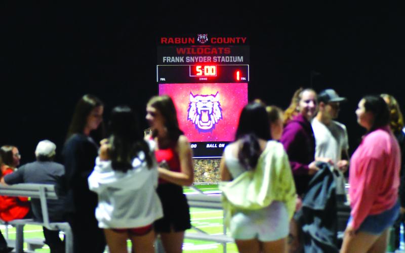 Enoch Autry/The Clayton Tribune. With the jumbotron in the background, students show up before the Wildcats take the field at Midnight Madness for the first official practice.