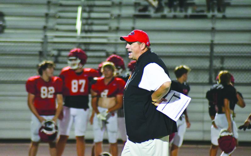 Enoch Autry/The Clayton Tribune. RCHS head coach Michael Davis watches his Wildcats during Midnight Madness practice on July 31. The Wildcats scrimmage Bowdon Friday.