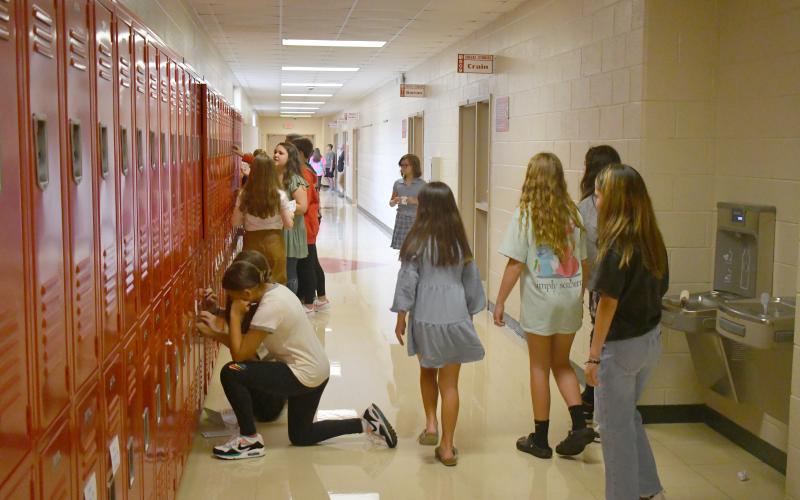 Enoch Autry/The Clayton Tribune. Rabun County Middle School students get their first chance to try out their new school lockers. Below:RCES student Reese Dean selects the book “Ranger In Time” from the school library.