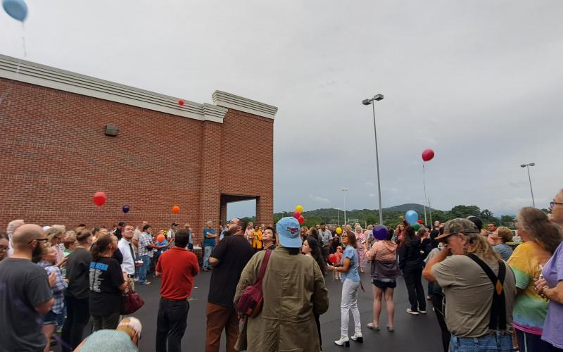 Megan Broome/The Clayton Tribune. Rabun County community members held a Candlelight Vigil at the north end of Ingles in Clayton Aug. 7 to honor the life of Rabun Gap man Frank Hanrahan, who suddenly died in a motor vehicle crash July 31. Hanrahan worked at the Clayton Ingles for 23 years and those honoring him lit candles, played “Amazing Grace” and released 23 balloons representing his 23 years at the business.