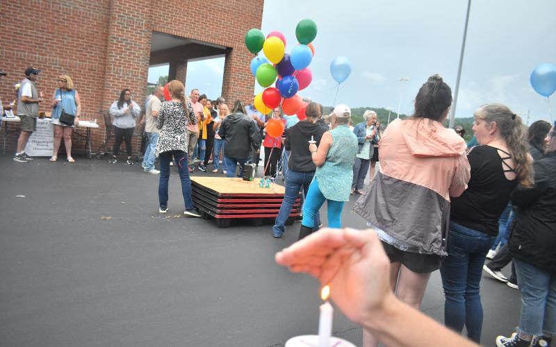 Megan Broome/The Clayton Tribune. Rabun County community members lit candles and released 23 balloons for Frank Hanrahan to honor his life and represent his years of service to Ingles.