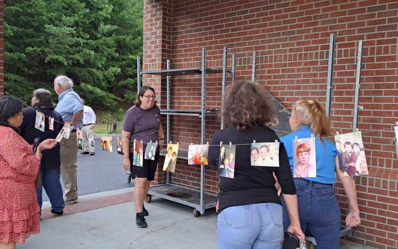 Megan Broome/The Clayton Tribune. Rabun County community members held a Candlelight Vigil at the north end of Ingles in Clayton Aug. 7 to honor the life of Rabun Gap man Frank Hanrahan, who suddenly died in a motor vehicle crash July 31. Pictures from Hanrahan’s life were displayed during the event.
