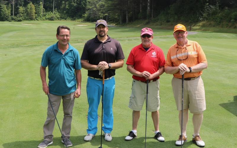 Submitted photos. The tournament team of Ron Barteski, Luke Fogarty, Dan Magliota and Chris Pence are ready to tee off at the next hole at the Sky Valley Country Club. Left: Ken Walton, Vickie Heher and Patrick Heher watch as Roberta Walton lines up her putt during the Sid Weber Memorial Cancer Fund Annual Golf Tournament. Ken Walton is the current SWMCF president.