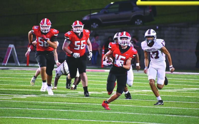 Wade Cheek/The Clayton Tribune. Sophomore RB and DB Reid Giles races Braves defenders to the end zone to set up a Wildcat touchdown in the 45-13 victory.
