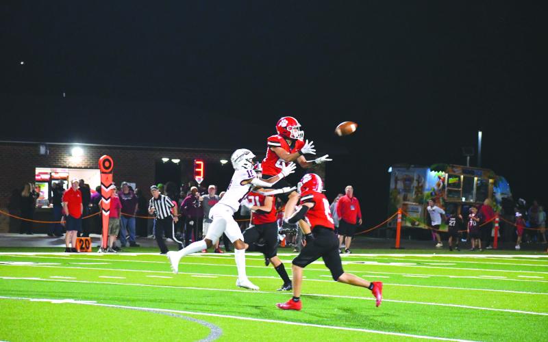 Wade Cheek/The Clayton. Tribune junior Jake Payne elevates over Heard County receiver Brody Buc Cofield to secure one of the Wildcats’ three interceptions in last Friday’s 45-13 win over the Braves. RCHS now is No. 5 in state.