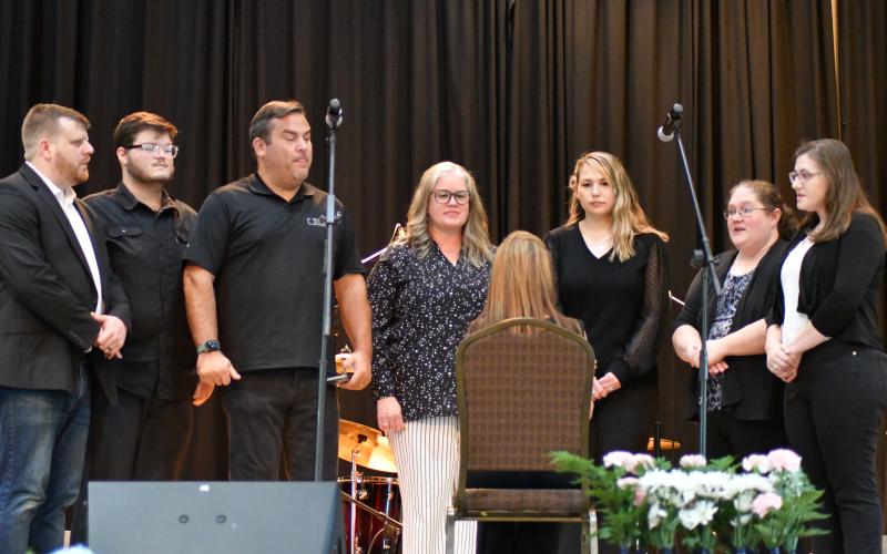 Enoch Autry/The Clayton Tribune. Members of the Church of the Mountains perform at the event. Below:  Sheriff Chad Nichols sits with his 6-year-old son Chatham at the banquet.