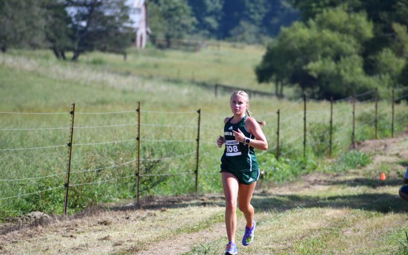 Wade Cheek/The Clayton Tribune. Rabun Gap freshman Bailey Brackett races to the finish line to take first place in the girls race on Aug. 31.
