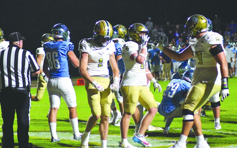 Enoch Autry/The Clayton Tribune. Trey Horne (1) flexes his muscles after scoring a rushing touchdown. Horne also had TDs on a kickoff return and punt return. He even threw a TD pass too.