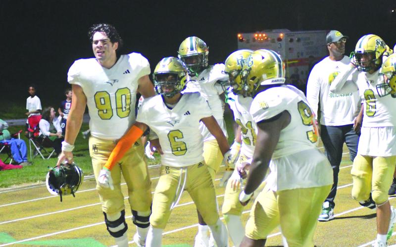 Enoch Autry/The Clayton Tribune. RGNS junior Patrick Williams celebrates with Eagle teammates after recording his first of two interceptions last Friday night against Valor Christian (Colo.) Williams, who also had a pick-six in the game, recently received an offer to play football at the University of Tennessee.