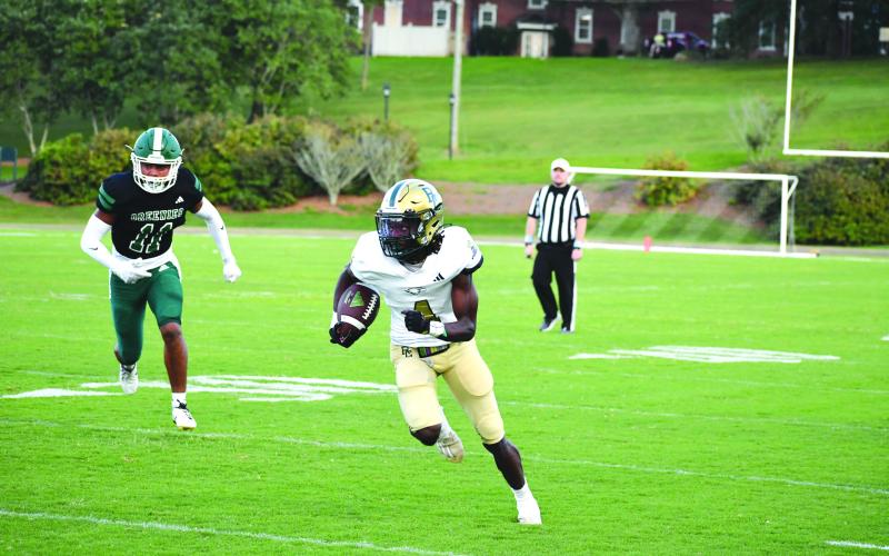 Wade Cheek/The Clayton Tribune. RGNS sophomore C.J. Willingham escapes Greenie defenders on his way to the end zone during last Friday’s win against Christ School.