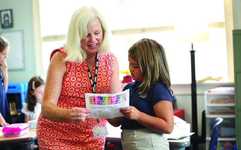 Photo courtesy Rabun Gap-Nacoochee School. Second-grade teacher Erin Williams and Blake Ruiz '34, of Otto, NC, in class on the first day of school at Rabun Gap-Nacoochee School. Rabun Gap welcomed back 675 students on August 23.