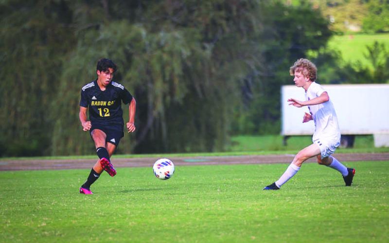 RGNS Athletics. RGNS Sophomore Gabriel Ruelas distributes the ball to Eagle teammates during 4-3 win over Providence Day on Aug. 31.