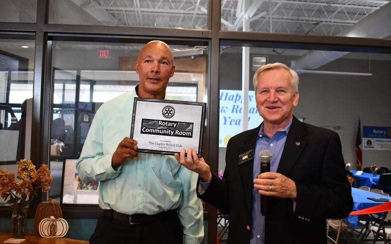 Megan Horn/The Clayton Tribune. James Brim, director of the Food Bank of Northeast Georgia Mountain Branch and Rotarian (left) is recognized by Rotary Club of Clayton President Gerald Hulett, for his partnership in helping establish the Rotary Community Room, during the grand opening and dedication event Sept. 14.