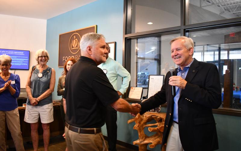 Megan Horn/The Clayton Tribune. Rotarian Tim Ranney, president of the Clayton Rotary Foundation, is thanked by Rotary Club of Clayton President Gerald Hulett for his efforts in renovating the Rotary Community Room, during the grand opening and dedication event Sept. 14.