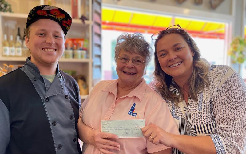 Submitted photo. The Aug. 21 Spaghetti Dinner Raise a Fork for Great Causes fundraiser at Clayton Cafe &amp; Market raised $4,550 for Rabun Paws 4 Life. Pictured are Chef Seth Curtis (left), Bonnie Edmonds, owner/operator of Clayton Cafe &amp; Market, and Ara Joyce.
