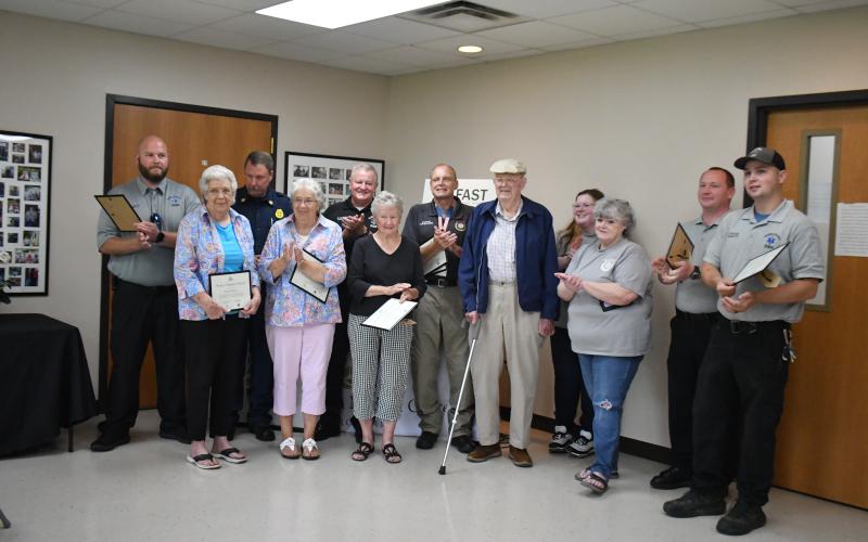 Megan Horn/The Clayton Tribune. Pictured ar e Logan Carnes with Rabun County EMS; Beverly Mason; Justin Upchurch, assistant chief Rabun County Fire Services; Marilyn Ballew; Mike Carnes, EMS/911 director; Jane Thomason; Gregg Dover, CAD/911 network manager; Daniel “Jack” Smith; Katie Coalley with Rabun 911; Kenette Turner with Rabun 911; Jonathan Watts with Rabun EMS/fire; and Tate Nichols with Rabun EMS.