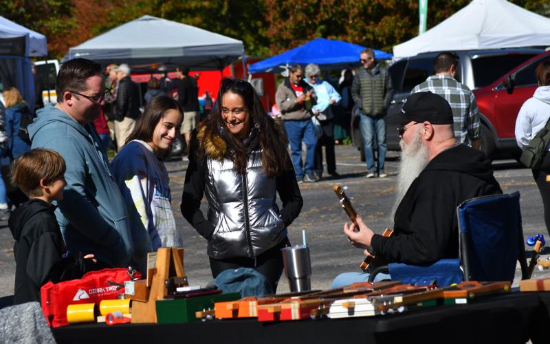 Enoch Autry/The Clayton Tribune. A picture-perfect day greeted people at the annual Sky Valley Fall Festival on Oct. 21. Below: Third place in the Hay Bale Trail competition went to Bartram Trail Conservancy for their hay bale shaped like a shoe with animals that promoted hiking the trail and staying active.