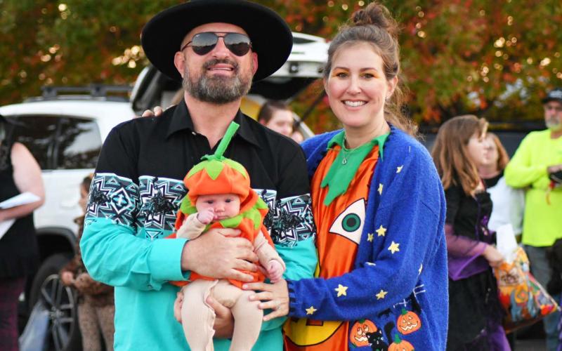 Enoch Autry/The Clayton Tribune. Michael and Melissa Persoon hold onto whom they deemed the youngest in attendance -- 5-week-old Savannah Lily.Below: Enoch Autry/The Clayton Tribune. Popeye loves his spinach, but he must enjoy some candy too. Isaiah Brown, 3, is dressed as the strong man as he strolls with his family and his 6-year-old sister Isabella Brown who portrayed the role of Olive Oil.