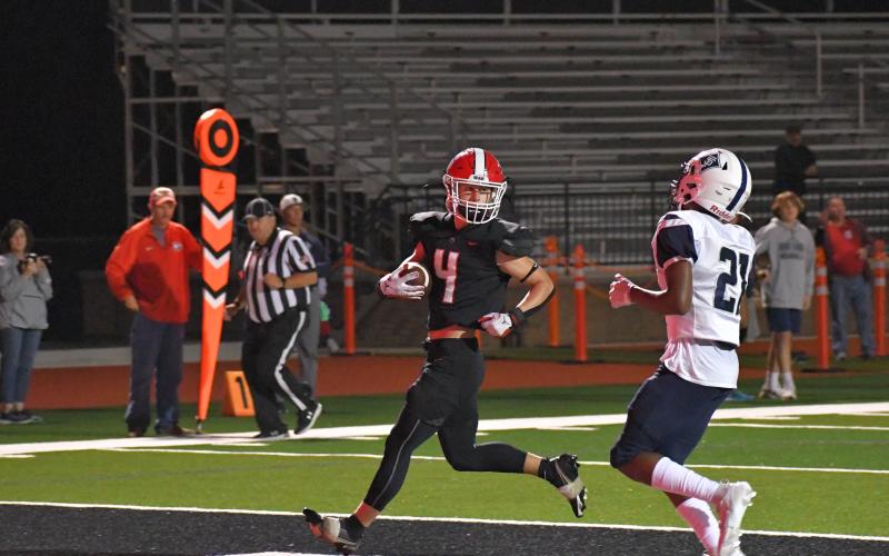 Wade Cheek/The Clayton Tribune. RCHS running back Noah English scores his first of two touchdowns, a 17-yard run, in last Friday’s route of the Knights.