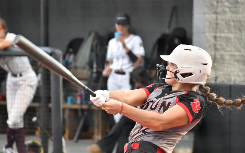 Wade Cheek/The Clayton Tribune. Lady Cat senior shortstop Mili Watts cracks a two-run home run over the right field wall to increase RCHS’s lead to 4-0 against Chestatee on Monday night. The Lady Cats won the game 13-1.