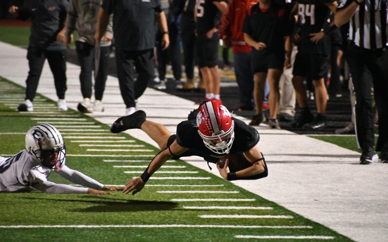 Wade Cheek/The Clayton Tribune. RCHS wide receiver Riley Stewart dives for extra yards in Blue Devil territory during last Friday’s region matchup against Elbert County. Yards were not as easy to find for the Wildcats as they fell 21-9.