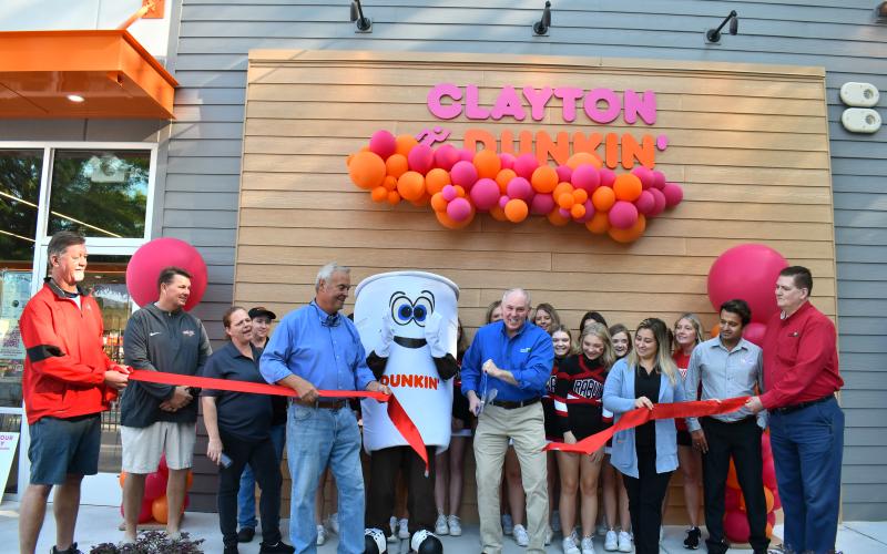 Megan Horn/The Clayton Tribune. The community showed out as Dunkin’ Donuts in Clayton held its official ribbon cutting and grand opening with Forward Rabun/Rabun County Chamber of Commerce Sept. 30. Below: Megan Horn/The Clayton Tribune. Lucy Woerner poses with Cuppy during the Sept. 30 Dunkin' Donuts grand opening.