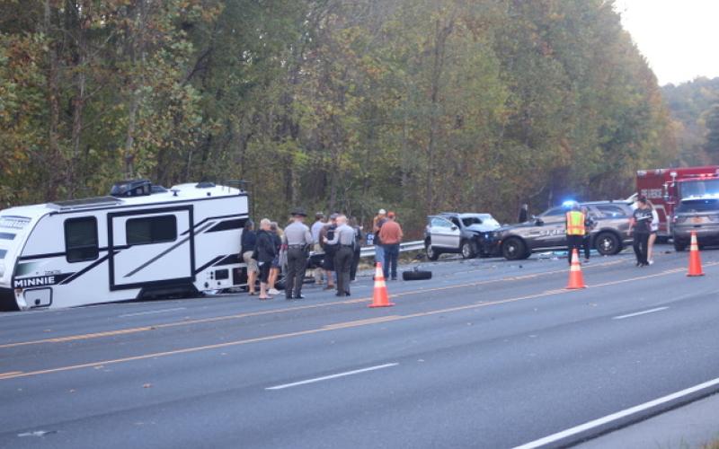 Thomas Sherrill/The Franklin Press. Emergency personnel from North Carolina work the scene of a four-vehicle crash with one fatality and other injuries on Georgia Road in Otto, N.C., Friday, Oct. 20. The scene left extensive damage on the roadway. The North Carolina State Highway Patrol is investigating the crash that caused traffic to back up as the road was closed for over four hours.