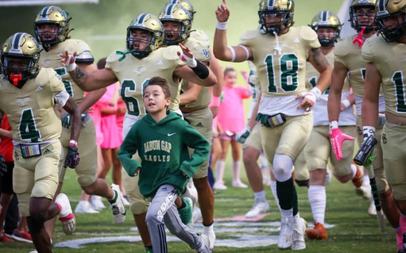 RGNS Athletics. RGNS football players and young fans sprint onto the field, dressed in pink, before the Eagles’ 57-22 victory over Metrolina Christian. RGNS is now 8-0 for the first time in program history.