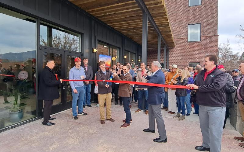 Megan Horn/The Clayton Tribune. Local officials and community members celebrate as the Bridge Creek Inn cuts the ribbon with Forward Rabun/Rabun County Chamber of Commerce during the Open House event Nov. 25.