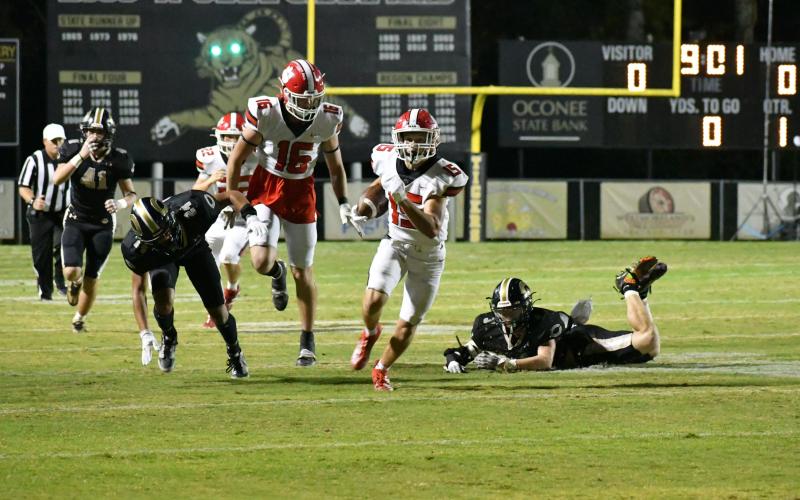 Wade Cheek/The Clayton Tribune. Rabun County sophomore running back Reid Giles sprints to the end zone in last Friday’s region loss to Commerce. Should the Wildcats had won, they would have won their 10th-straight region championship.