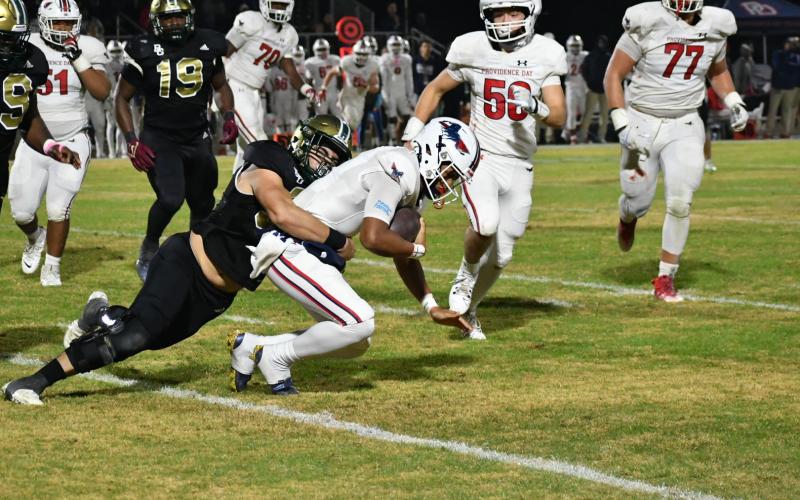 Wade Cheek/The Clayton Tribune. Rabun Gap’s Hector Gonzalez registers a sack of Providence Day quarterback Jadyn Davis in the NCISAA state championship game on Nov. 17. The Eagles came up just short in the battle at home, 34-27.