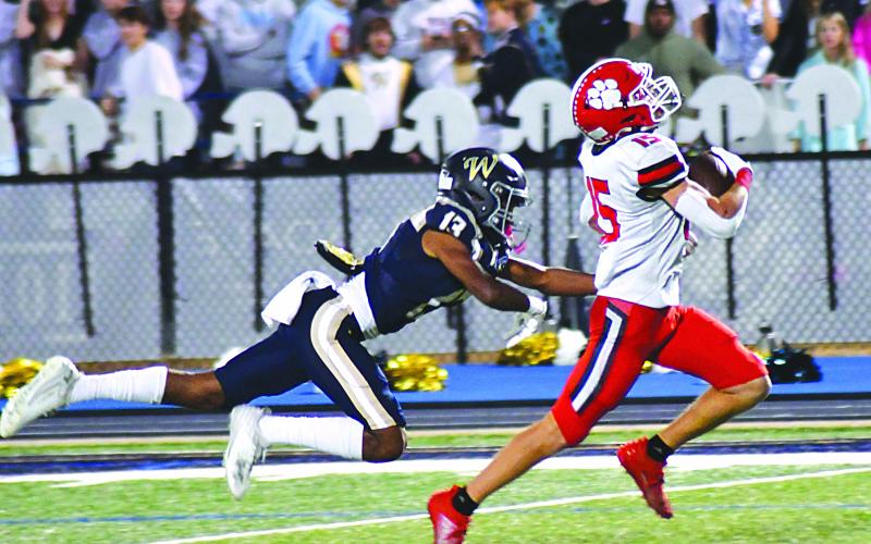 Enoch Autry/The Clayton Tribune. Wildcat running back Reid Giles breaks multiple tackles at the line of scrimmage and then outraces John Durden and other Whitefield Academy WolfPack defenders 56 yards for a touchdown. Reid led the Wildcats in rushing with 104 yards and two scores in RCHS’s 42-14 win to move into the state Elite Eight.