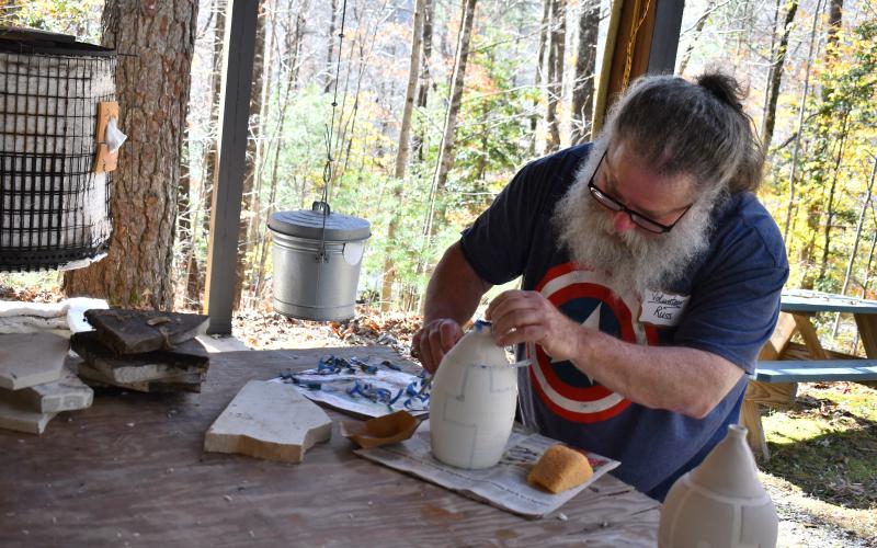Megan Horn/The Clayton Tribune. Russ Gerber demonstrates Raku firing technique at the Hambidge Center open house event for the Antinori Village Nov. 4. Left: Photo courtesy Forward Rabun/Rabun County Chamber of Commerce. Forward Rabun/Rabun County Chamber of Commerce congratulated the Hambidge Center on their ribbon cutting.