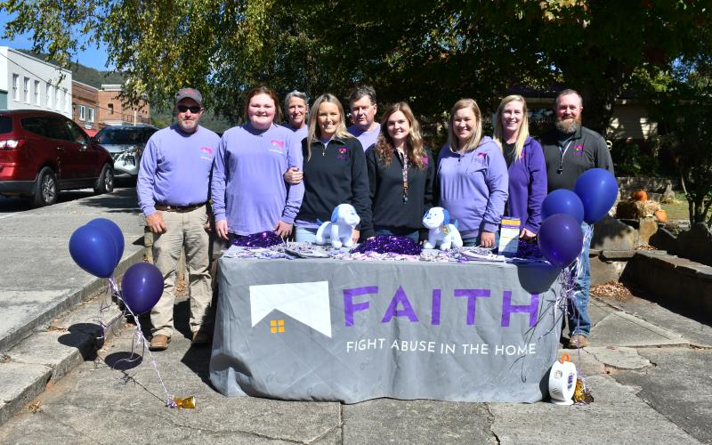 Megan Horn/The Clayton Tribune. Fight Abuse in the Home (F.A.I.T.H.) organized many events during October for Domestic Violence Awareness Month, including a Hope Walk where many community members walked in downtown Clayton while local businesses stood in solidarity holding candles on the sidewalk to bring awareness.
