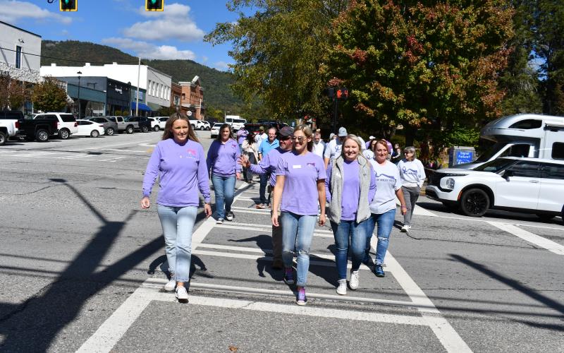 Megan Horn/The Clayton Tribune. Fight Abuse in the Home (F.A.I.T.H.) organized many events during October for Domestic Violence Awareness Month, including a Hope Walk where many community members walked in downtown Clayton while local businesses stood in solidarity holding candles on the sidewalk to bring awareness.