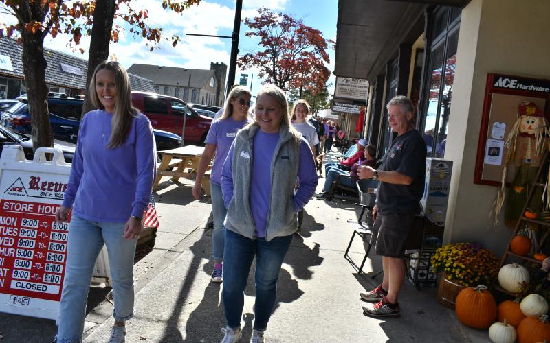 Megan Horn/The Clayton Tribune. Fight Abuse in the Home (F.A.I.T.H.) organized many events during October for Domestic Violence Awareness Month, including a Hope Walk where many community members walked in downtown Clayton while local businesses stood in solidarity holding candles on the sidewalk to bring awareness.
