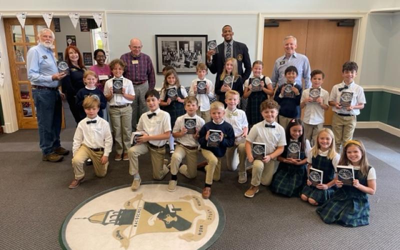 Submitted photo. Rotary Club members present dictionaries to third grade students at Rabun Gap-Nacoochee School.