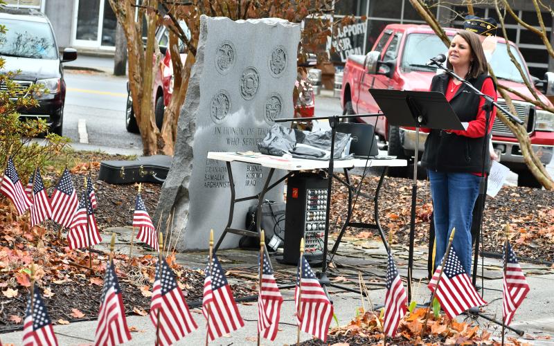 Megan Horn/The Clayton Tribune. Lora Burrell sang “The Star-Spangled Banner” and then the crowd was led in the Pledge of Allegiance by Wayne.