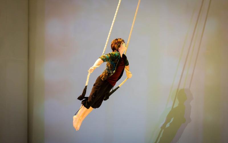 Photography submitted. Allen Arbitter ’26 of Clayton performs on the trapeze in “Cirque Synthetica.”