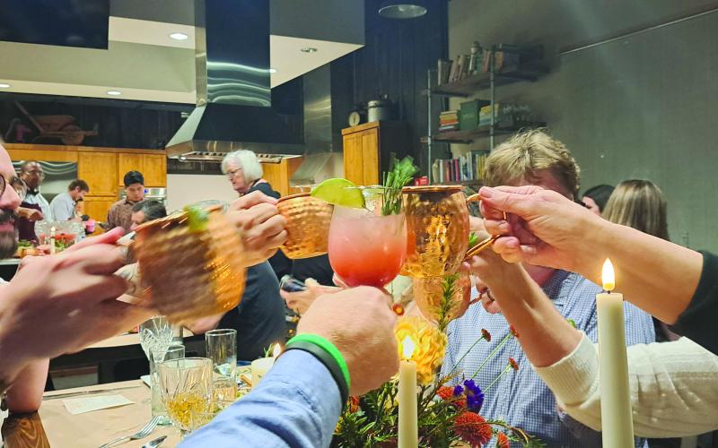 Megan Horn/The Clayton Tribune. Guests toast to a culinary adventure during a cocktail-inspired small plates teaching dinner at the Food Bank of Northeast Georgia Teaching Kitchen.