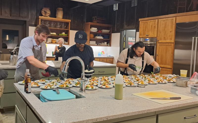 Megan Horn/The Clayton Tribune. Local Chef Alex Stein and his staff prepares the five-course meal for guests.