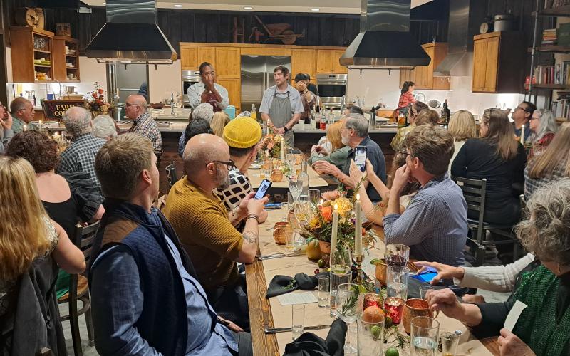 Megan Horn/The Clayton Tribune. Carlton Chamblin and Local Chef Alex Stein speak to guests during the event.