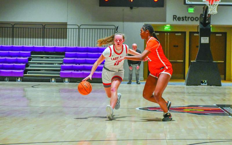 Wade Cheek/The Clayton Tribune. ady Cat senior guard Lucy Hood searches for an open teammate against Chambers High School during Rabun County’s 42-17 win in the Insider Exposure Cherokee Invitational on Dec. 20. Hood, who is headed to Western Carolina on a basketball scholarship, totaled 40 points across the three-day tournament.